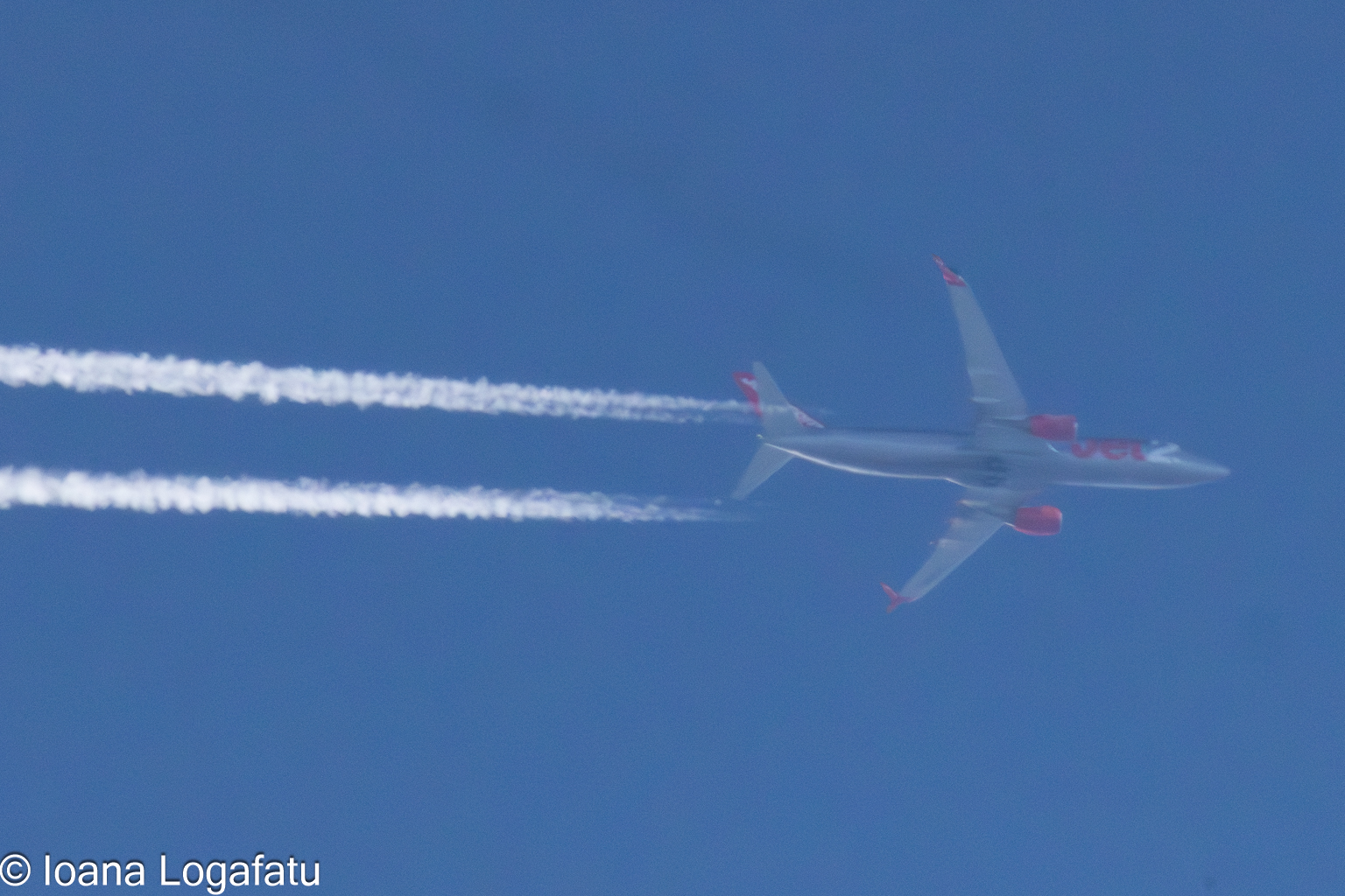 Airplane soaring through the clear blue sky